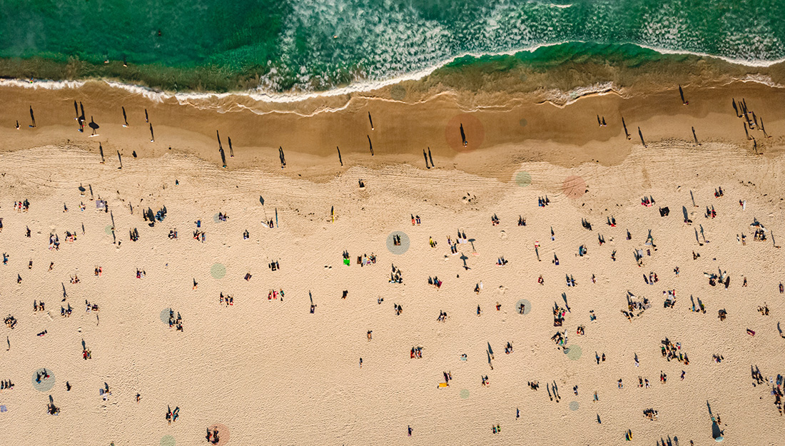 Aerial view of beach with people and surf